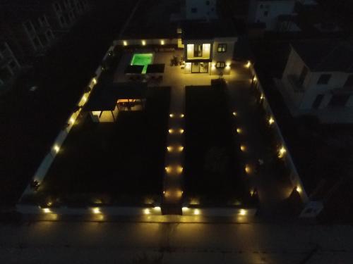 a building with lights on it at night at Luxury Villa Plaka Litochorou with Pool in Plaka Litochorou