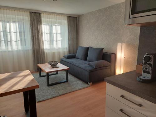 a living room with a couch and a table at Glatz Haus Siegesbrunn in Bad Waltersdorf