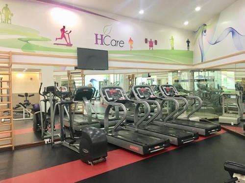 a gym with rows of treadmills and elliptical machines at Holiday Inn Olaya by IHG in Riyadh