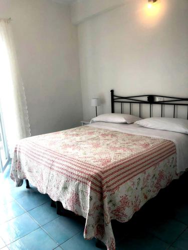 a bedroom with a bed with a blanket on it at Sea View Sirolo di Amedeo in Sirolo