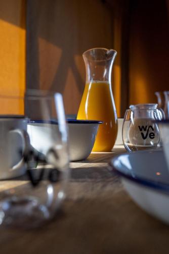 a table with two glasses and a bowl and a vase at The Camp at The Wave in Bristol