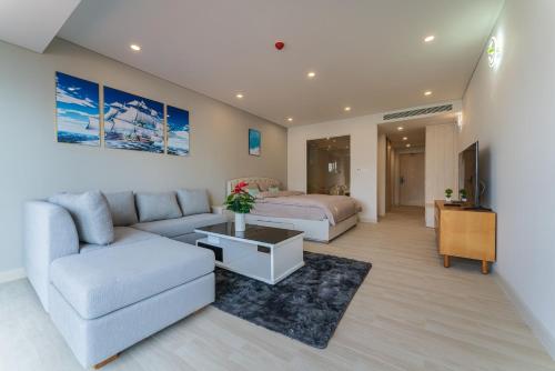- un salon avec un lit et un canapé dans l'établissement HighSea GoldCoast Superview Apartment, à Nha Trang
