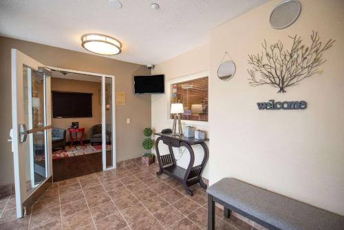 a living room with a couch and a table at Sonesta Simply Suites Chicago Naperville in Warrenville