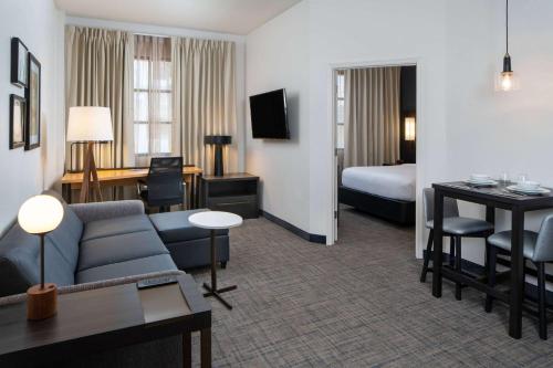 a hotel room with a couch and a bed at Sonesta ES Suites New Orleans Convention Center in New Orleans