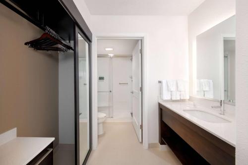 a white bathroom with a sink and a toilet at Sonesta ES Suites Atlanta Kennesaw Town Center in Kennesaw