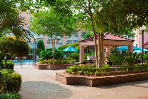 a pavilion in a park with trees and a building at Sonesta ES Suites New Orleans Convention Center in New Orleans