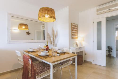 a dining room with a table and chairs at Golden Beach in Jávea
