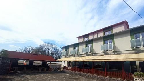 a building with balconies on the side of it at Motel Šofér in Volkovce