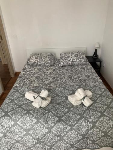 a bed with two pairs of shoes on it at Ozas Apartment 1 and 2 in Vilnius