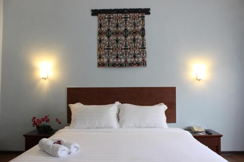 Postel nebo postele na pokoji v ubytování Hotel Maluri