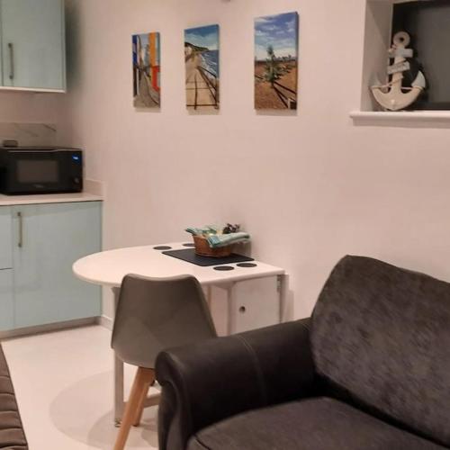 a living room with a chair and a table at Sycamore Lodge Kent With EV Zappi type 2, swimming pool for a fee in Sellindge