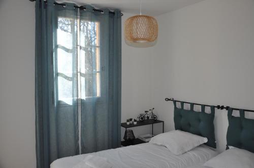 a bedroom with a bed and a window at Villa Côte & Provence - private heated pool in Fayence