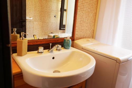 a bathroom with a sink and a toilet and a mirror at Appartamento con vista mare a Terramala in Terra Mala