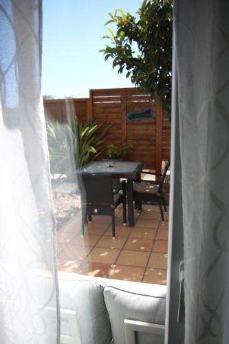 a view of a patio with a table and chairs at Pine Tree Apartments - Praia da Coelha - Albufeira in Albufeira