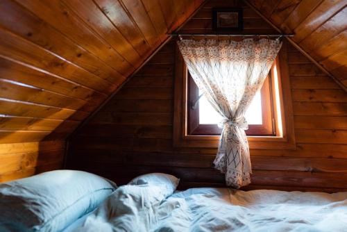 a attic bedroom with a bed and a window at Korbielówka in Korbielów