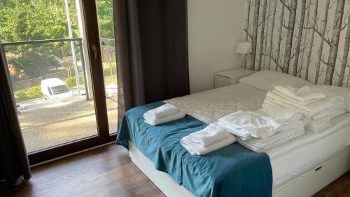 Posteľ alebo postele v izbe v ubytovaní Apartament nad jeziorem , ZEFIR