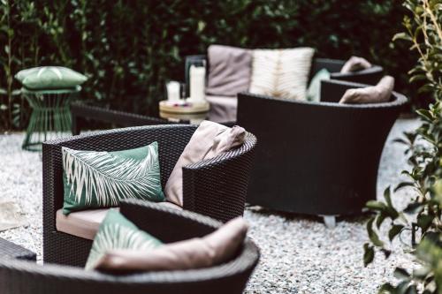 a group of chairs with pillows on a patio at Palazzo Feroci - Residenza d'epoca in Pisa