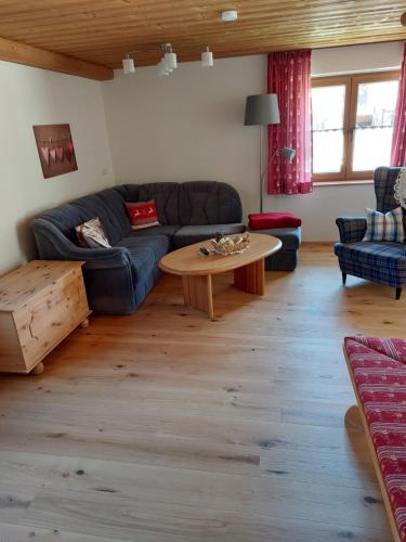 a living room with a couch and a table at Haus Alpenrose in Schwangau