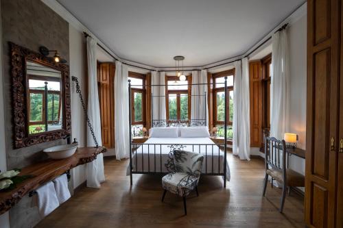 a bedroom with a bed in a room with windows at POSADA SEMILLA in La Abadilla