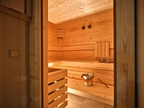 a wooden sauna with a tub and a bucket at The Spa Suite Top 3- Tauplitz Residences by AAHH in Tauplitz