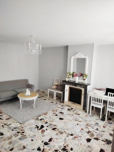 a living room with a couch and a fireplace at Maison de village - Suite Baroque cosy et élégante à 1 h de Paris proche Fontainebleau 