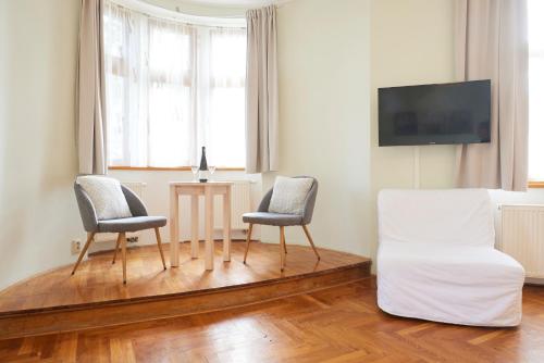 a living room with two chairs and a table and a couch at Wellness Penzion U Muzea in Liberec