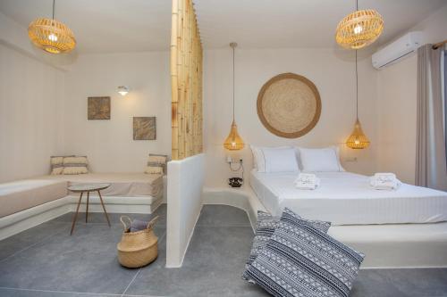 a white bedroom with two beds and a tub at Ampelos Residence Naxos in Naxos Chora