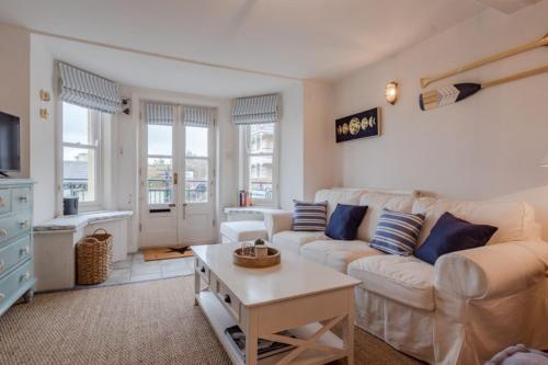 a living room with a couch and a table at Beach House in Cromer