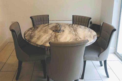 a dining room table with four chairs around it at Townhouse Clifden: Located in the heart of Connemara in Clifden
