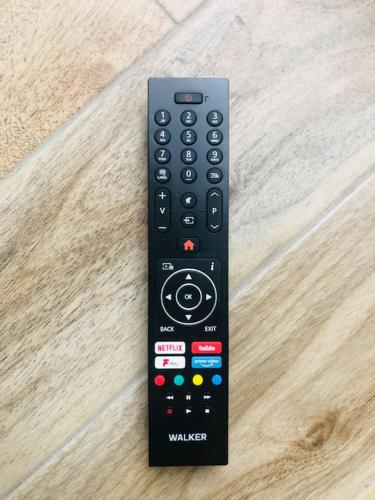 a remote control sitting on top of a wooden floor at Townhouse Clifden: Located in the heart of Connemara in Clifden