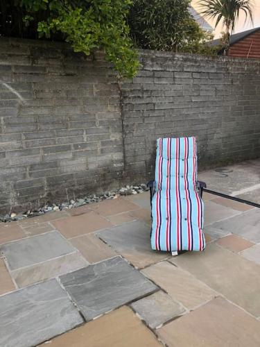 a suitcase sitting on the ground next to a brick wall at Townhouse Clifden: Located in the heart of Connemara in Clifden