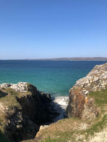 a view of the ocean from a cliff at Townhouse Clifden: Located in the heart of Connemara in Clifden