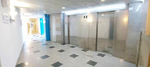 a hallway with a glass elevator in a building at beach front tel aviv bat yam apartment -hotel 39 in Bat Yam