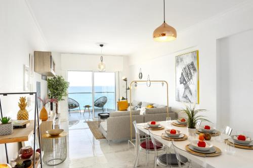 a living room with a table and a couch at Lovely 3-bedroom apartment in Prokymea court in Limassol