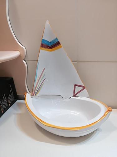 a bowl shaped like a boat sitting on a table at LA BARCHETTA suite in Orosei