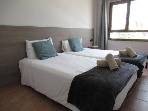 2 łóżka w pokoju hotelowym z poduszkami w obiekcie NÁUTICO Suites, by Comfortable Luxury - Adults Only w Corralejo