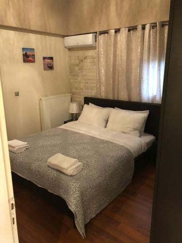 a bedroom with a bed with two towels on it at Luxury Apartments Christos in Gouvia