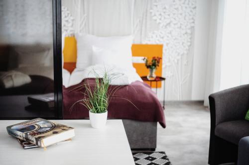 a bedroom with a bed and a table with a book at RIVA Szeged in Szeged
