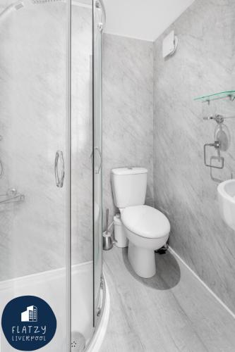 a bathroom with a shower and a toilet and a sink at FLATZY - Victoria Street Apartment - Heart of City Centre in Liverpool