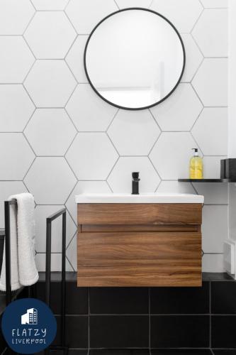 a bathroom with a sink and a mirror at FLATZY - Victoria Street Apartment - Heart of City Centre in Liverpool