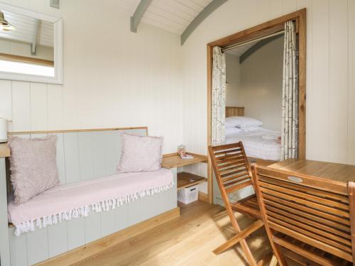 a bedroom with a mirror and a bench and a bed at Cherry Blossom in Bristol