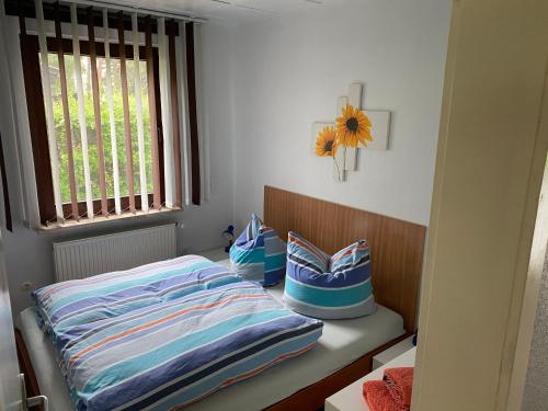 a bedroom with a bed and a window with a sunflower at Maximilian in Plau am See