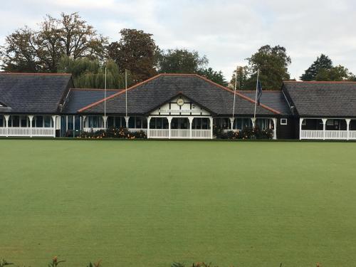 un gran edificio con un gran campo verde en Jersey Villa Guest House, en Warwick