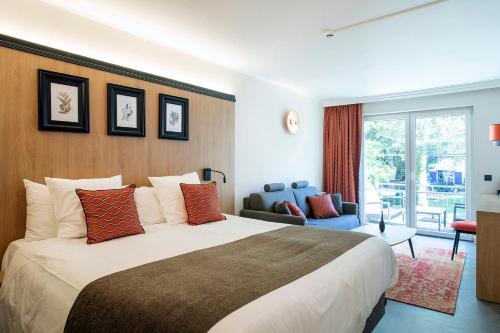 Postel nebo postele na pokoji v ubytování Hôtel Les Ardillières du Pont d'Oye