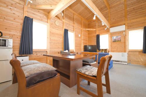a room with a desk in a wooden cabin at LAKE TOYA Logde SIGRA in Lake Toya