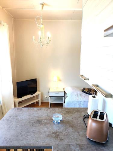 a living room with a bed and a chandelier at Reipas in Kotka