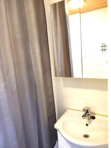 a bathroom with a sink and a mirror at Reipas in Kotka