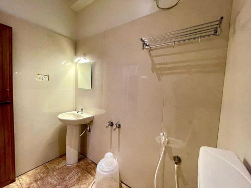 a small bathroom with a sink and a shower at Ashray Residency in Vānivilāsa Puram