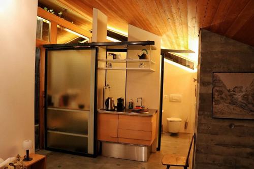 a small kitchen with a sink in a room at Chalet Morgane in Grindelwald