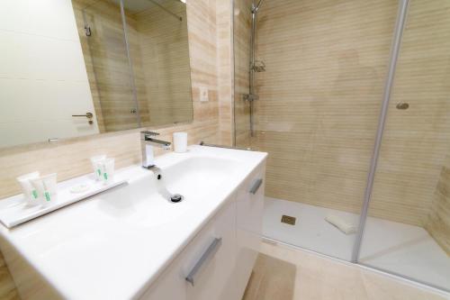 a bathroom with a sink and a shower at Aqua Apartments Bellamar, Marbella in Marbella